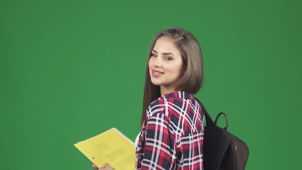 Gorgeous Cheerful Female Student Smiling Over Her Shoulder