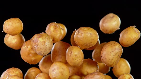 Super Slow Motion Shot of Flying Potatoes Isolated on Black Background at 1000 Fps