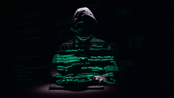 Guy Writes Patches for Hacking Web Sites. Black Background. Silhouette