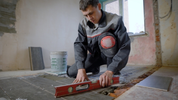 Master Is Wearing Work Clothes, Is Checking Horizon of Installing Tiles, Using Building Level