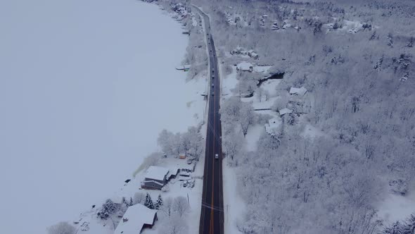 Aerial snow covered busy highway during a winter day