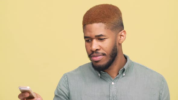 Portrait of Metis Handsome Guy with Stylish Haircut Reading Funny News Good Information on Mobile