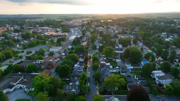 Aerial shot of a small town in the United States in the evening. Beautiful homes, businesses, street
