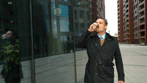 Businessman Walking with Coffee Near Business Centre