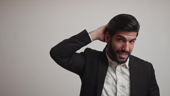 Confident Young Bearded Cuban Businessman Entrepreneur Stroking His Shiny Healthy Hair and