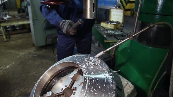 Worker Drilling Metal on the Machine