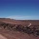 Car Driving on Gravel Road in Aerial Desert - VideoHive Item for Sale