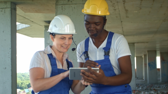 Construction People Using Electronic Tablet on Site alt