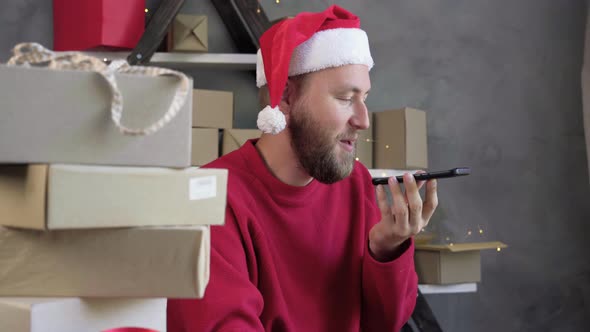 Young Caucasian Man in Santa Claus Hat Working From Home Online Shopping Logistics and Delivery of