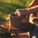 View of Craftsman’s Hands Creating a Vessel, While Moving a Disk of Pottery Wheel with His Legs - VideoHive Item for Sale