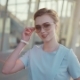 Beautiful European Girl Smiling Seductively Towards the Camera, Putts Off Her Stylish Sunglasses - VideoHive Item for Sale
