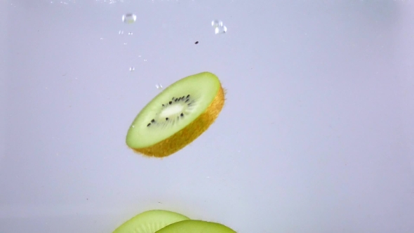 Pieces of Kiwi Drops Under Water