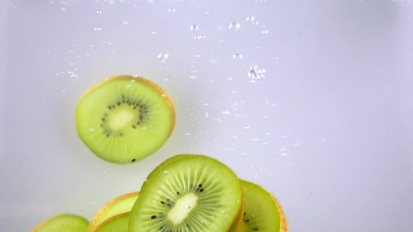 Slices of Kiwi Falling Into Water