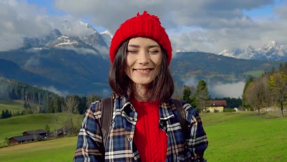 Portrait Free Happy Young Hiker in Red Hat Woman Looking at Camera Enjoying Calm Alps Day in Nature