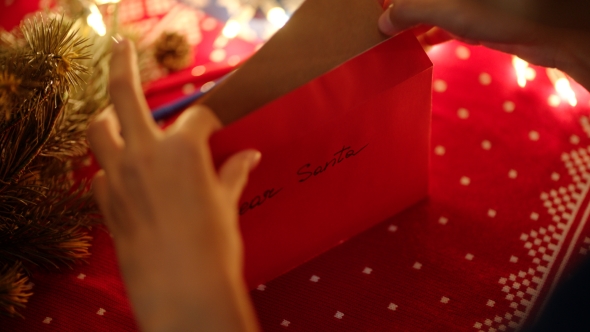 Putting a Christmas Letter in the Envelope To Santa 