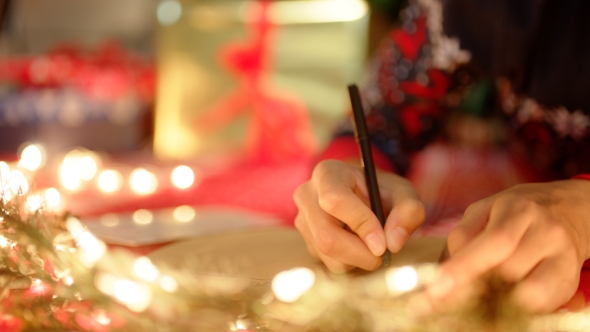 A Girl Is Writing a Letter To Santa Claus in New Years Eve