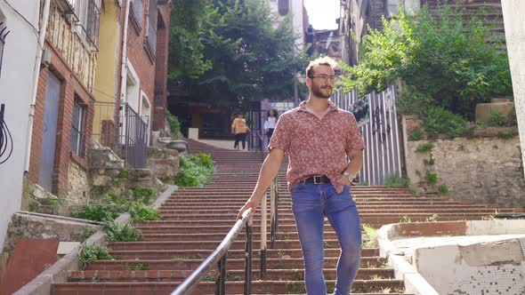 Young man walking on historic street.