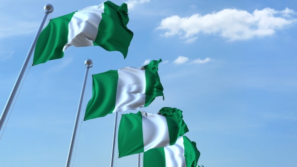 Multiple Waving Flags of Nigeria Against the Blue Sky