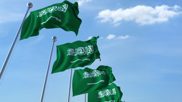 Multiple Waving Flags of Saudi Arabia Against the Blue Sky