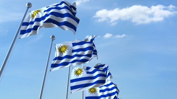 Multiple Waving Flags of Uruguay Against the Blue Sky alt