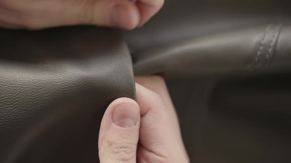 Top Down Shot of Man Hand Inspecting Soft Gray Leather