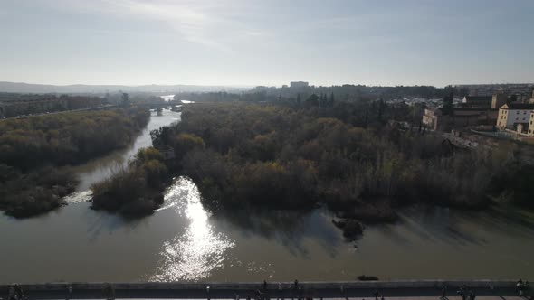 Aerial pullback over Roman bridge spanning Guadalquivir; Cordoba, Spain