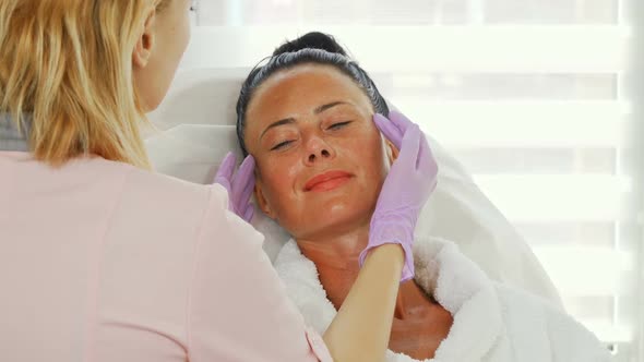 Professional Cosmetologist Examining Face of Her Female Client 1080p