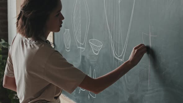 Woman Drawing on Chalkboard