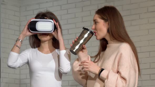 Two Lovely Female Friends Using 3d Virtual Reality Goggles Together