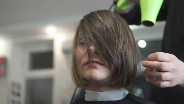 Young Woman Getting Her Hair Dressed in Beauty Salon