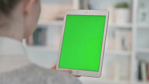 Rear View of Woman Using Tablet with Chroma Key Screen