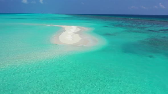 Aerial drone view panorama of marine coast beach holiday by blue green water with white sandy backgr