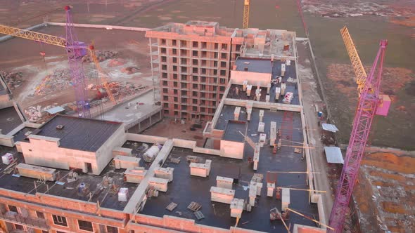 Construction Site in the Middle of the City and Private Houses at Sunset in