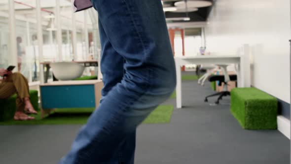 Businessman exercising on treadmill while talking on mobile phone in m 4k