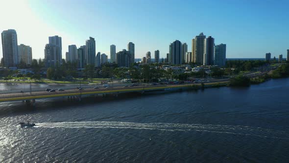 Boat in gold Coast waterway, just after sunrise, drone view