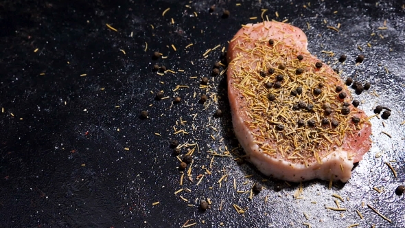 Fly Over  Crane Footage of Raw Piece of Pork Meat Seasoned with Pepper, Salt and Spices