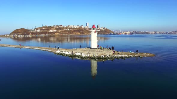 Lighthouse on Tokarev Cat on the Background of the Sea Landscape.