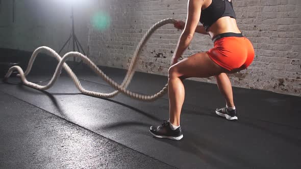 Battling Ropes Girl at Gym Workout Exercise Fitted Body. Slow Motion