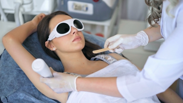 Beautiful Woman Getting Permanent Laser Hair Removal at Beauty Salon