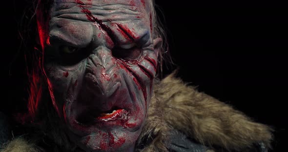 Heavy Breathing and Panting Orc with Blood on His Face, Black Background, 