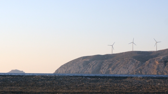 Wind Turbine Power Generators at Ocean Coastline at Sunset
