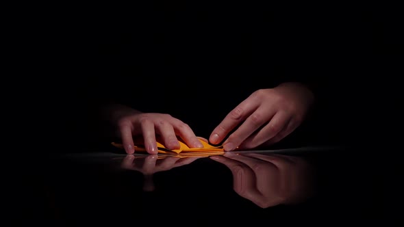 Hands Makes Yellow Origami. Black. Closeup