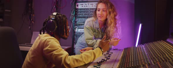 Man and Woman Having Discussion in Recording Studio