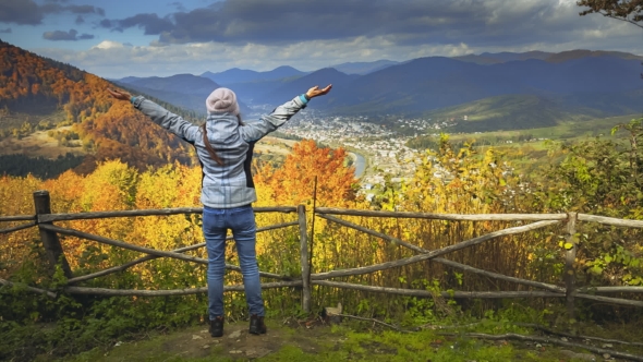 Young Woman Raising Hands on Mountain View Point