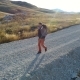 Tourist with a Backpack Is Walking Along a Gravel Road - VideoHive Item for Sale