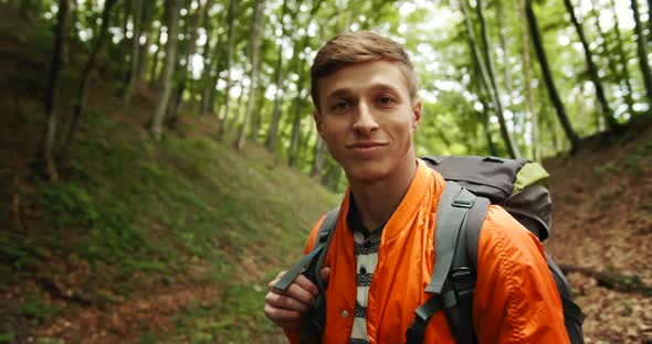 Portrait of Man with Backpack in Forest