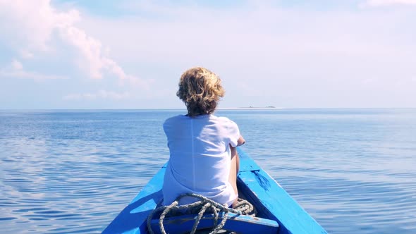 Slow motion: woman sunbathing relaxing on boat cruising blue water tropical