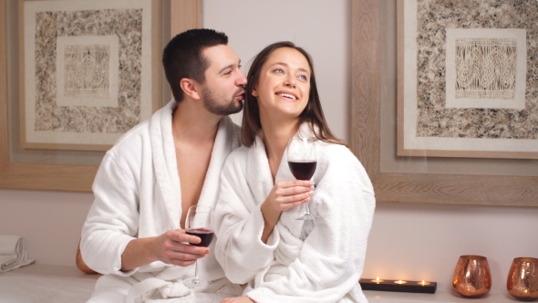 Happy Beautiful Couple Drinking Champagne and Relaxing in a Spa Centre.