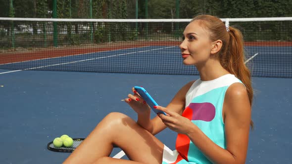 Tennis Girl Surfing the Net While Relaxing