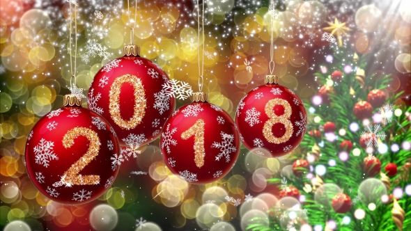 Red Balls with Numbers 2018 Hanging on the Background of a Bokeh and a Rotating Christmas Tree